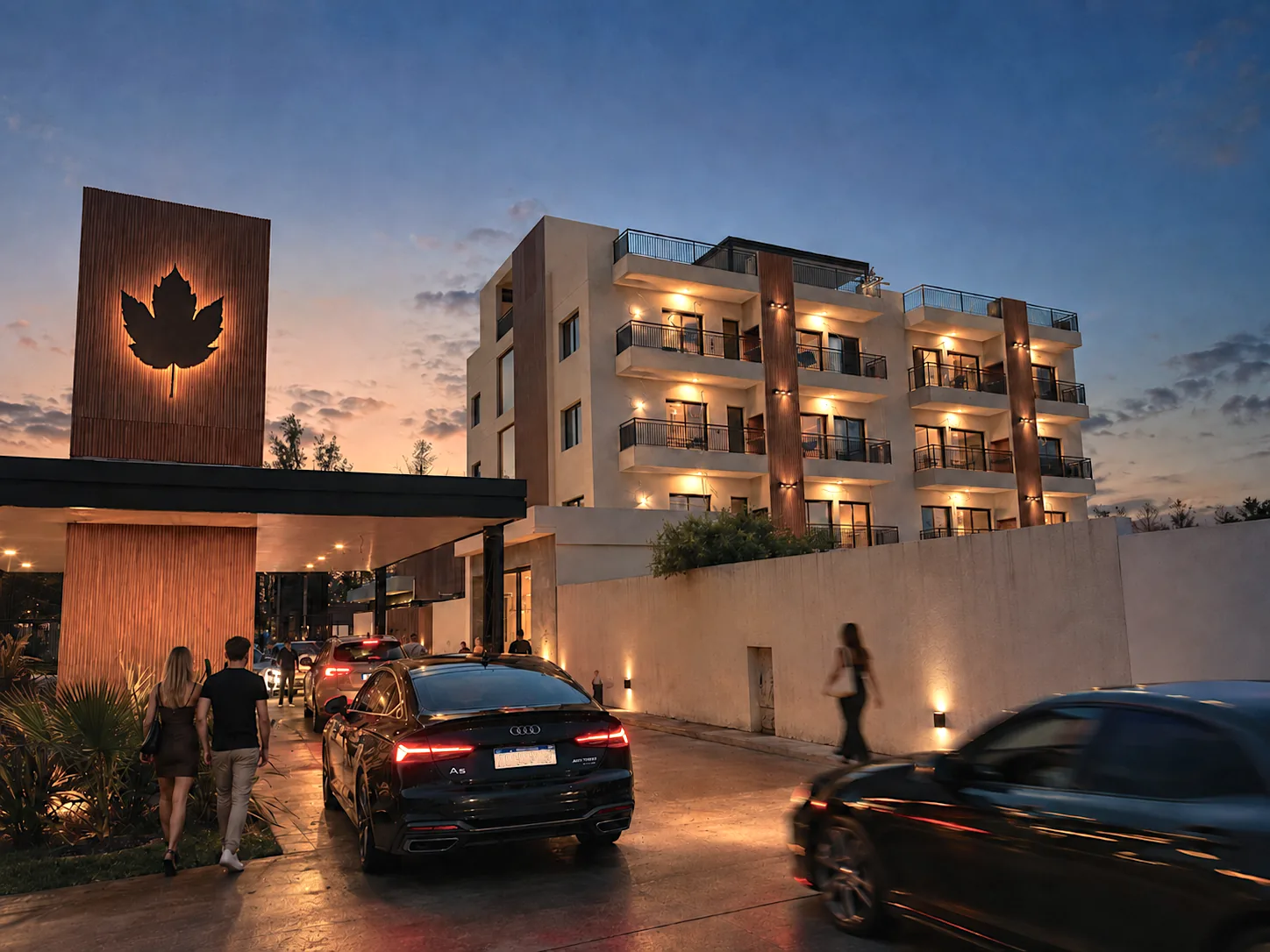 SpringPark Apartments al atardecer, con el logo iluminado en la entrada